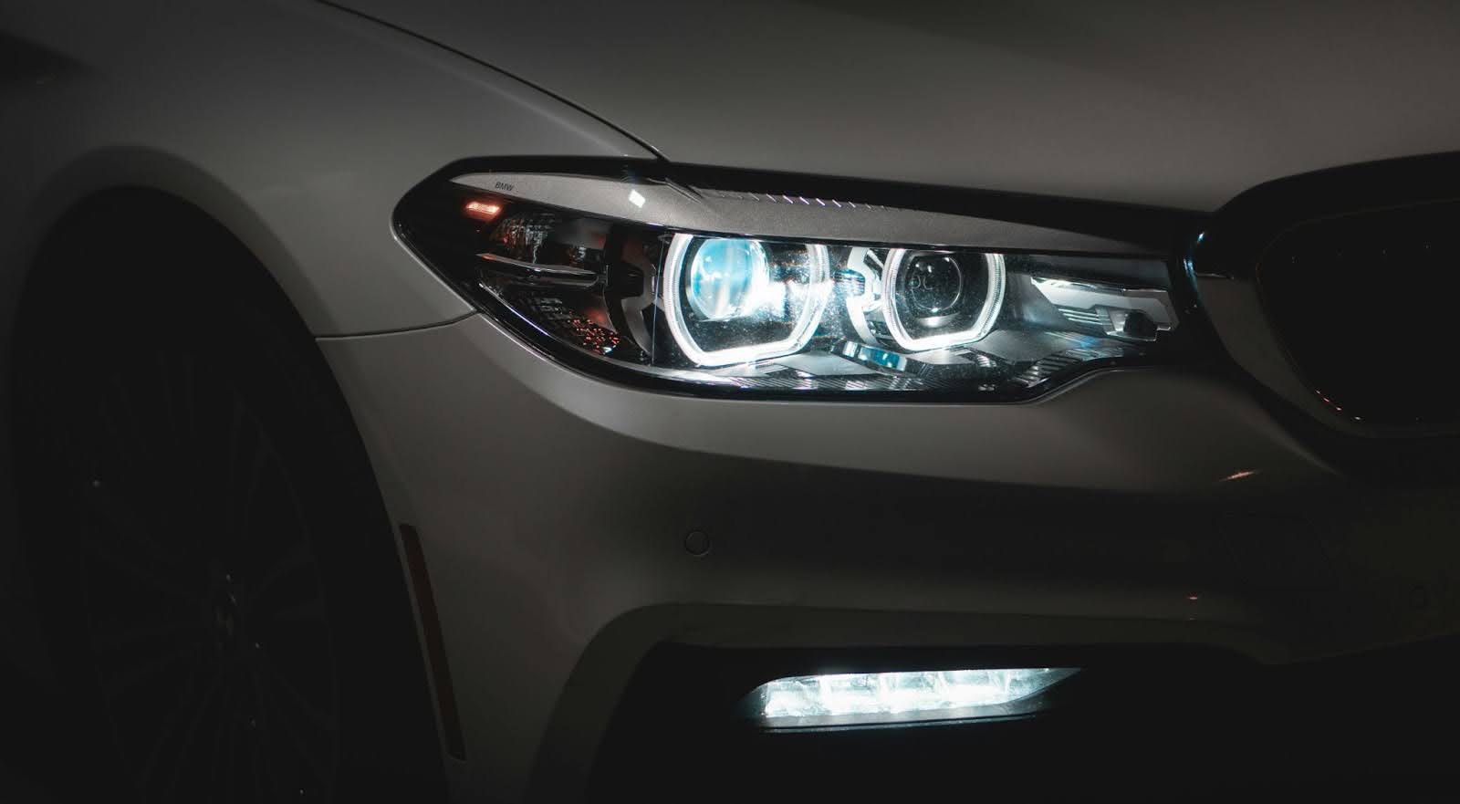 A close-up of a headlight on a black car