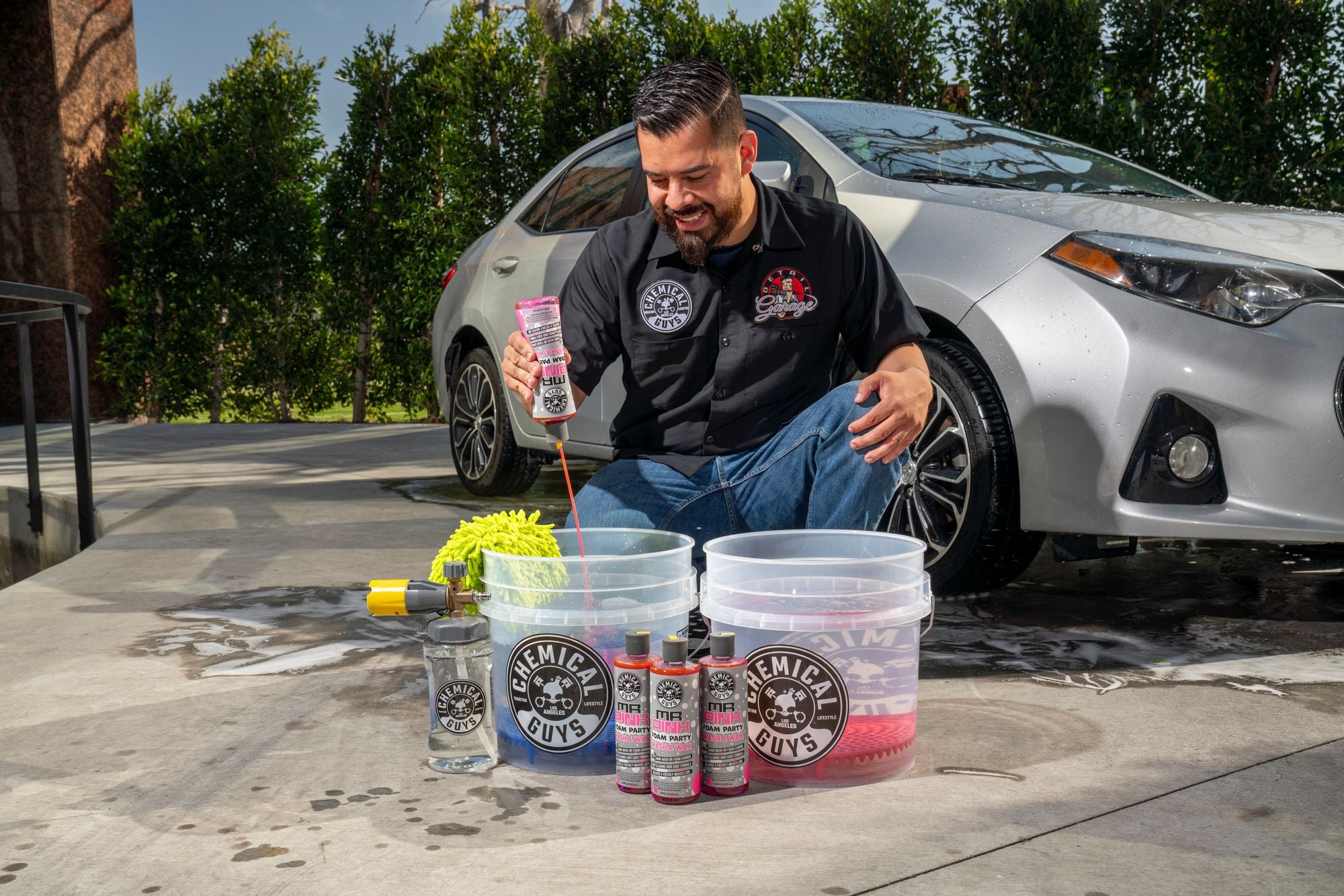 Getting ready to wash a car by adding Mr. Pink Foam Party to a car wash bucket